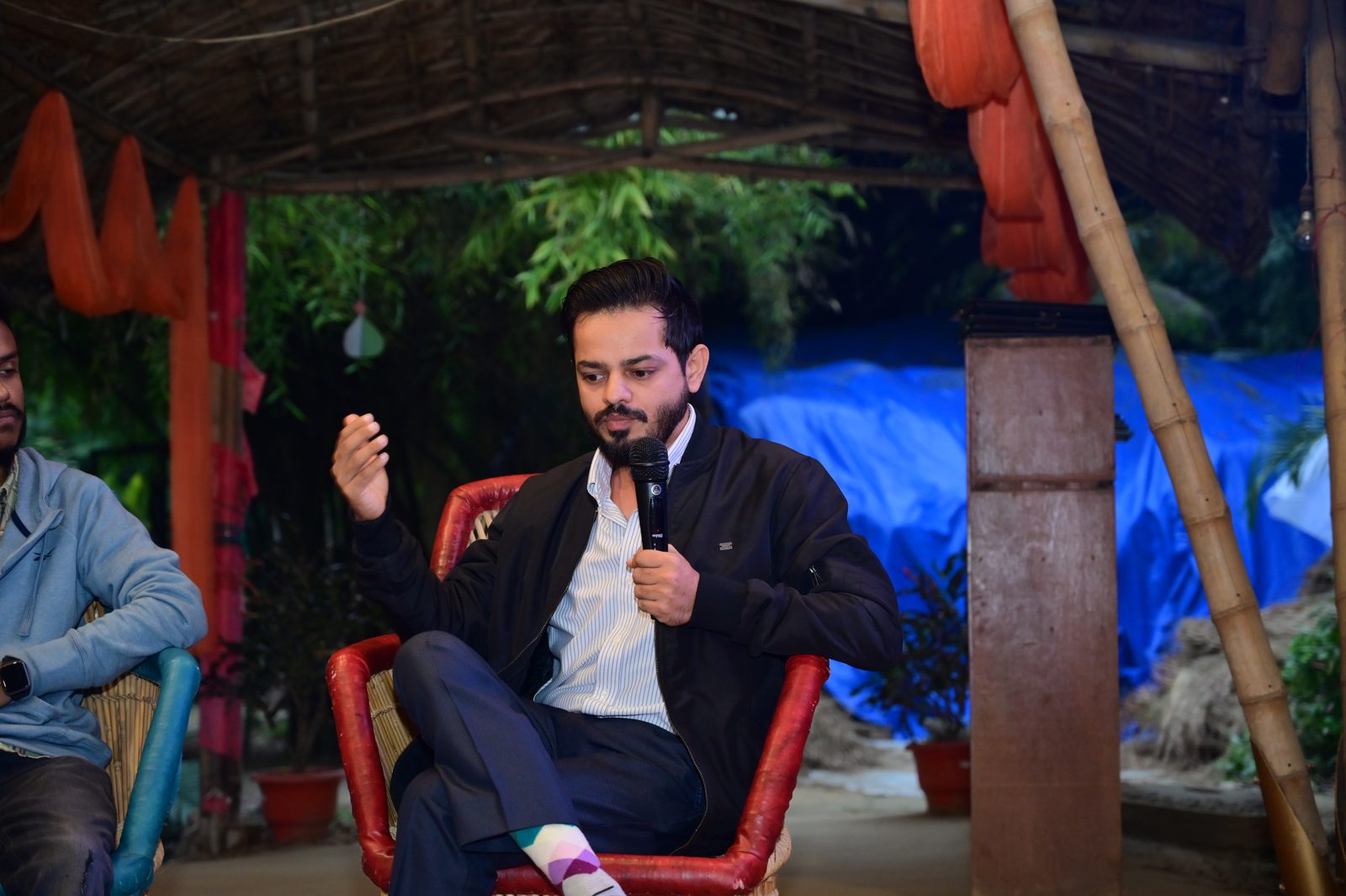 Hemant Sharma speaking with a mic at a panel event